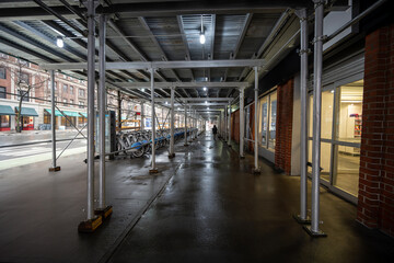 Passing under scaffolding near buildings on a street in New York
