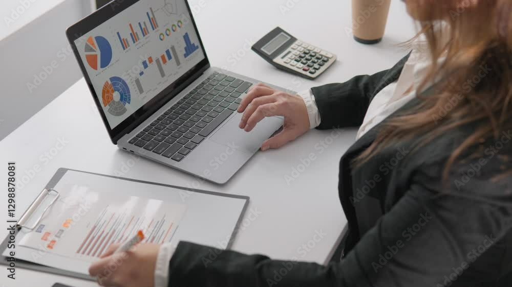 Poster a professional woman is currently analyzing comprehensive data on her laptop within an office settin