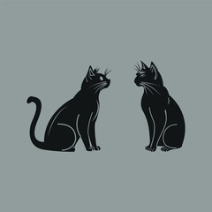 Two Black Cats Sitting