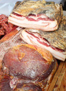 smoked pork meat called guanciale for sale in a shop in central italy