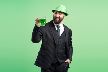 Elegant businessman drinking green beer celebrating St. Patrick's Day