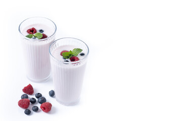 Fresh raspberry and blueberry smoothie isolated on white background. Copy space