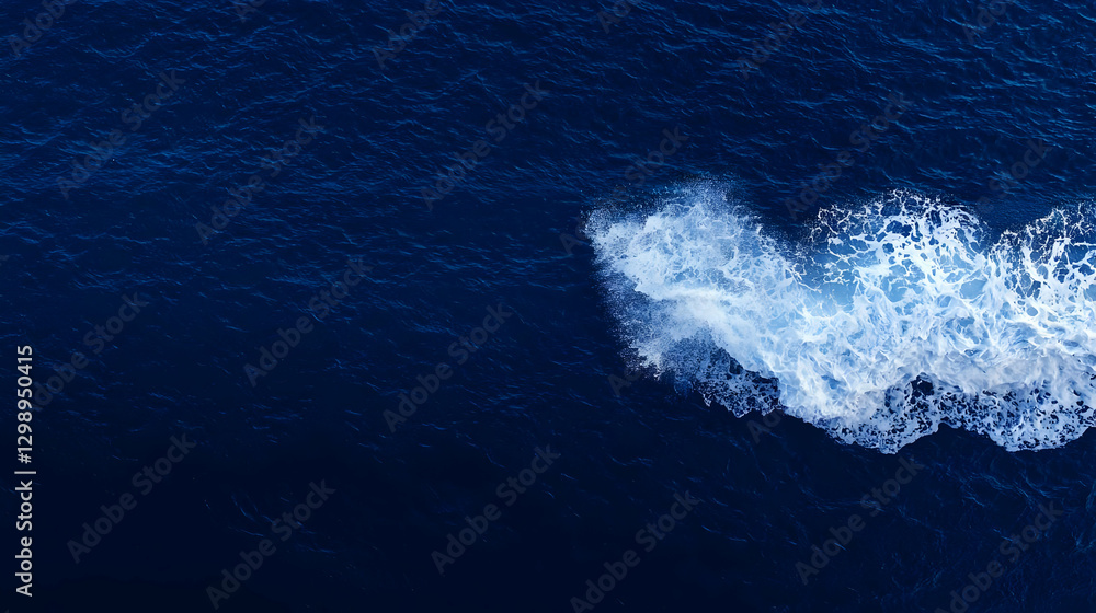 Aufkleber dark blue ocean water with white foamy wave splashing across the surface creating dynamic texture