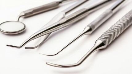 Close-up shot of stainless steel dental instruments on a clean white background