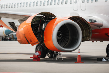 Aircraft jet engine maintenance. Opened cowling of passenger airplane engine, instrument toolboxes...
