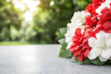 beautiful close up of floral wreath featuring red and white flowers, symbolizing remembrance and honor in serene outdoor setting