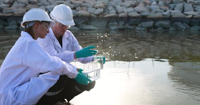 Environment Scientists examine water, collect water samples from industry, and analyze water. scientist Biologist or environment staff sample water for mobile lap test. Scientists examine toxic water.