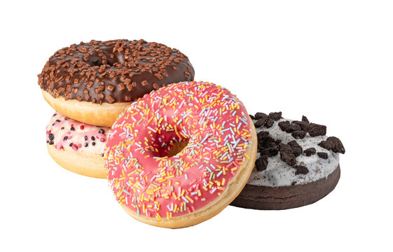 Four iced ring donuts with sprinkles and cookie crumbs on transparent background