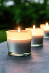 Softly glowing candles illuminate serene outdoor setting, creating peaceful ambiance