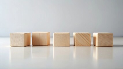 Obraz premium Five Unfinished Wooden Blocks Arranged in a Row on a Reflective Surface