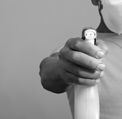 man with spray sanitising bottle beating the coronavirus on white background stock photo