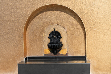 Doha, Qatar: black fountain on the golden wall