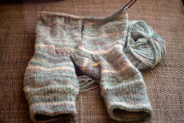 knitted socks made of wool yarn, handicraft concept, knit