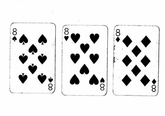 Vintage playing cards in black and white showing three of the same value.