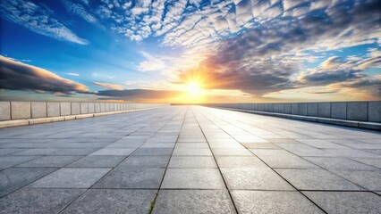 Open paved pathway extending towards a vibrant sunset with a low stone wall
