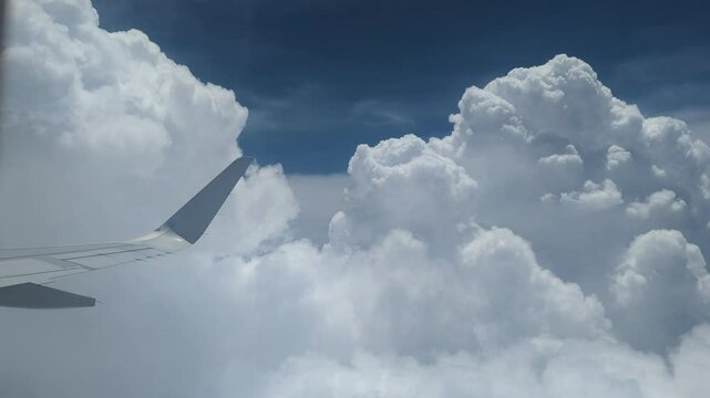 Beautiful cloudscape of airplane with fluffy clouds ina blue sky