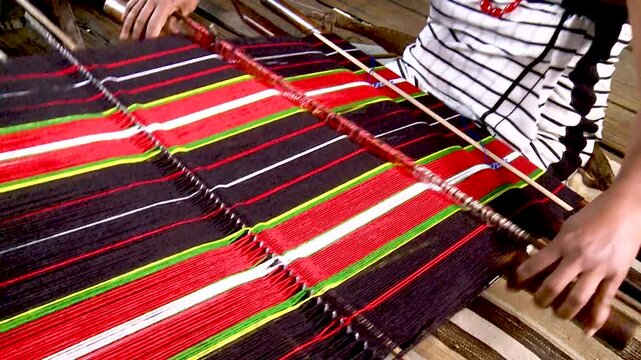 A Tribal woman of Assam weaving traditional cloth 2
