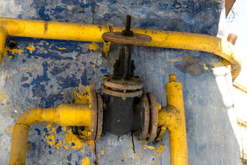 Old yellow gas pipes with valve