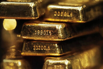 A close-up view of stacked gold bars with engraved serial numbers