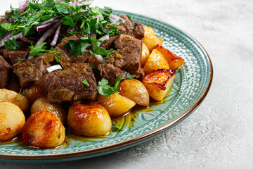 kuyrdak, roast offal with potatoes and fresh herbs, homemade in Kazakh, no people,