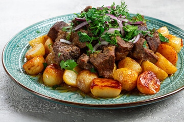 kuyrdak, roast offal with potatoes and fresh herbs, homemade in Kazakh, no people,