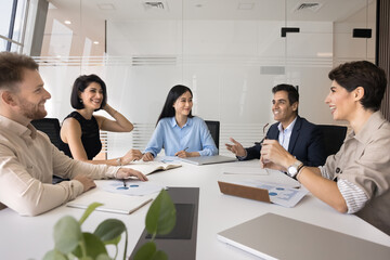 Successful idea. Young Asian businesswoman corporate team leader and diverse multiethnic business staff group listen to mature Indian man expert manager offer problem solution propose growth strategy