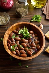 Baked red beans in bowl on wooden table
