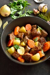 Beef stew with potatoes, carrots and greens