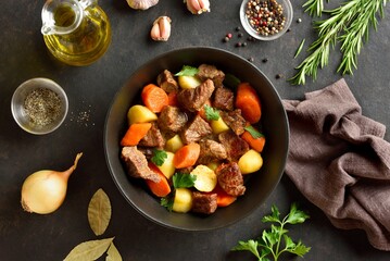 Beef stew with potatoes, carrots and greens