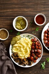 Mashed potatoes with roasted sweet and spicy sausage bites and mushrooms