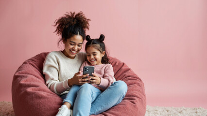 Joyful Mother-Daughter Bonding: Shared Smiles Over Mobile Phone for Mother's Day Marketing & Family Products