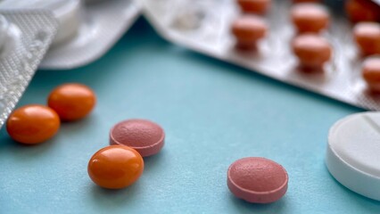 Assorted Pills and Blister Packs on a Blue Background, Medical and Pharmaceutical Concept