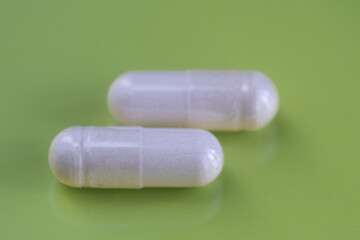 pills and bottle. A medicine, solid dosage of a medicine, usually a tablet, The medicine is small and solid.