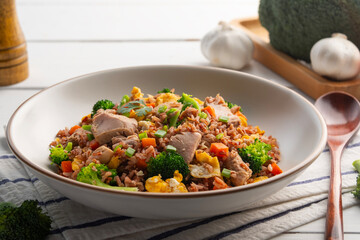 Tuna fried rice,Healthy asian food.Thai fried Organic Red Brown Jasmine Rice (unpolished rice) with canned tuna fish and broccoli carrot egg in white plate.clean food.