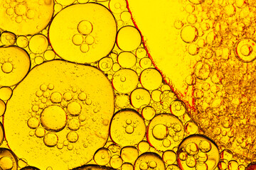 Yellow macro bubble background,Golden yellow abstract oil bubbles or face serum background. Oil and water bubbles macro photography.