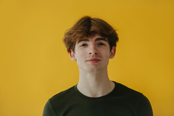 Portrait of a Young Man Smiling Against Bright Yellow Background