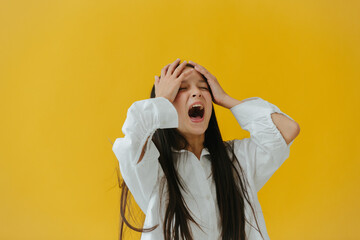 Frustrated Woman Expressing Anger in Front of a Bright Yellow Background
