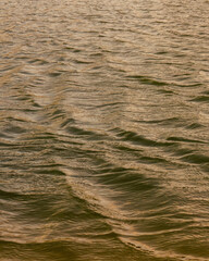Close-up view of the low waves on a  lake in the light of the afternoon, in a farm near the colonial town on Villa de Leyva, in central Colombia.