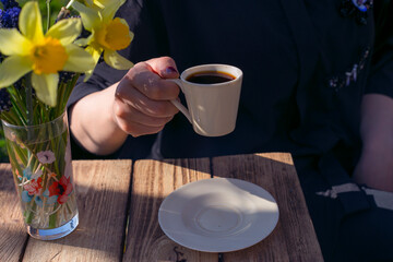 woman drinking coffee in garden close up