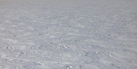 Lines and patterns in snow on frozen Alaskan lake