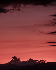 An intense pink afterglow illuminates the end of the sunset over the western Andean mountains of central Colombia, near the colonial town of Villa de Leyva.