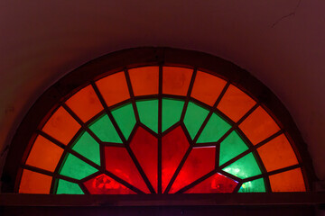 Fototapeta premium A window into the past, glowing with heritage. Wooden stained glass windows.