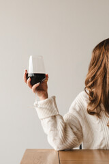 Woman holding a glass of red wine