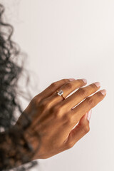 close up of hand with engagement ring
