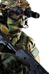 Special forces soldier with tactical gear and weapon in isolated background