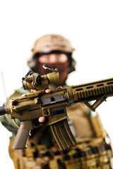 Close-up of a Tactical Assault Rifle Held by a Soldier Wearing Military Gear