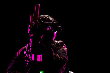 Silhouette of Soldier in Tactical Gear with Night Vision in Neon Lighting