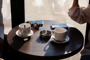 Friends in a restaurant talking smiling and drinking tea. Business colleagues having a meeting after work at a cafe bar. Abstract photo..