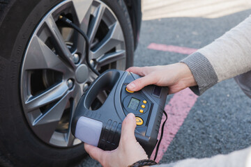 Checking tire pressure on an electric vehicle with digital gauge
