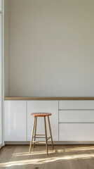 Minimalist interior with a wooden stool and sleek cabinetry in natural light